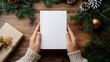 © Ziyan Yang - Hands holding book cover mockup on Christmas holiday