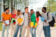 © Jose Calsina - A big group of teenage students laughing and talking on the university campus. Happy classmates having a conversation. Young multiracial people having a fun chat after class. Friends enjoying together