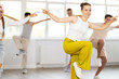 © JackF - Teenage girl and boys having dance training in studio, performing hip hop elements