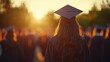 © Watasiwa - Graduation ceremony with student wearing a mortarboard in focus during sunset