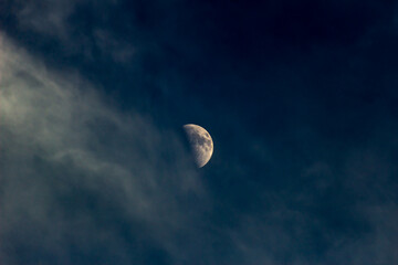Wall Mural - moon in the dark blue sky with white clouds, natural background.