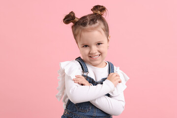 Wall Mural - Portrait of happy little girl on pink background