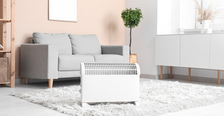 Poster - Electric convector heater in living room. Concept of heating season