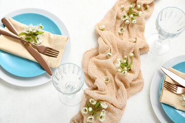 Wall Mural - Beautiful table setting with blooming tree branches on white background