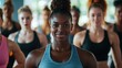 © Jeannaa - A confident woman leading a group workout session, showcasing strength and unity in fitness among diverse participants.