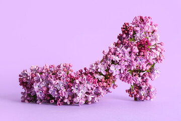 Wall Mural - High heeled shoe made of beautiful lilac flowers on color background