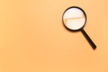 Wall Mural - Black magnifier on orange background