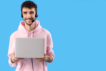 Poster - Male technical support agent with laptop on blue background