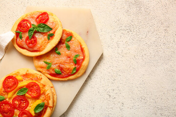 Wall Mural - Board with different tasty mini pizzas on white background