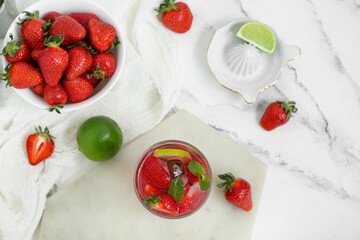 Wall Mural - Glass of delicious strawberry mojito on light background