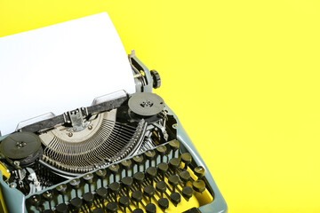 Wall Mural - Vintage typewriter on yellow background