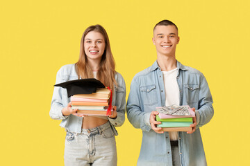 Sticker - Young students with books, graduation hat and money on yellow background. Concept of savings for education