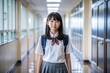 © nilawan - Japanese Schoolgirl in Uniform Standing in Corridor.