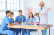 © Pixel-Shot - Mature doctor teaching medical students at university