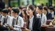 © Nittaya - Asian Male and female college students and businessmen attending a lecture, class, or seminar at a university or school