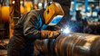 © supee - Industrial welder inspecting a welded joint for quality control