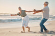 © peopleimages.com - Old couple, holding hands and playing on beach for love, travel and sea waves for retirement. Senior people, marriage and holiday for laughing by water, happy and silly wife on weekend vacation