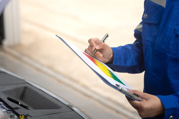 Wall Mural - an engineer is using a pen to checking on the safety risk assessment with color matrix form to evalu