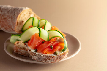 Wall Mural - Sandwiches with smoked trout, cream cheese, fresh cucumber and capers.