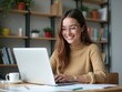 © Iresha - Attractive Student Woman Reading and Correcting Essay at Desk with Laptop, Preparing for Session and Diploma Work