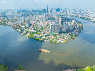 Wall Mural - Panoramic view of Saigon, Vietnam from above at Ho Chi Minh City's central business district. Cityscape with Landmark 81 skyscraper and many buildings, local houses, rivers.