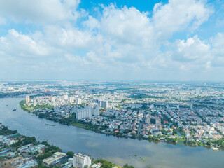 Wall Mural - Panoramic view of Saigon, Vietnam from above at Ho Chi Minh City's central business district. Cityscape and many buildings, local houses, bridges, rivers.