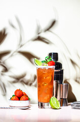 Wall Mural - Strawberry alcohol cocktail drink with tequila, grapefruit, lime juice,  mint and ice. Beige pink background., hard light