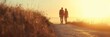 © nopommajun - A couple walks hand-in-hand along a serene path during golden hour, illuminated by the warm glow of the setting sun, enveloped in tranquility.