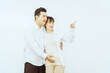 © Phushutter - A middle-aged Asian couple, with the woman being pregnant, shares a loving embrace, smiling with happiness and anticipation for their soon-to-arrive baby, symbolizing family togetherness and joy.