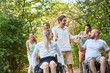 © Robert Kneschke - Group of friends, including people using wheelchairs, enjoying a sunny day outdoors together