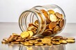 © Arethaawykoff - A transparent glass jar filled with shiny golden coins, surrounded by a few loose coins spilling out, against a soft, creamy white background.