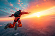 © TRAVELARIUM - Skydiver in freefall against backdrop of fiery sunset, capturing thrill of extreme adventure