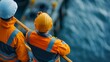 © sorrakrit - Two construction workers observe maritime operations, highlighting teamwork and safety in a marine environment.