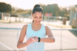 © Haas/peopleimages.com - Woman, smart watch and tennis court with smile for sports, stats and thinking in summer with app for game. Girl, person and happy with reminder for progress, check and heart rate for fitness in Spain