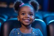 © Rajiv - Cheerful black little girl watching movie in theater, Generative AI