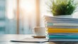 © narak0rn - Stack of colorful files on a desk with a coffee cup and tablet.