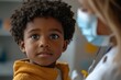 © Rajiv - Small black boy about to get vaccinated by pediatrician at doctor's office, Generative AI