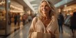 © Kakabe - A smiling woman carrying shopping bags is seen walking in a brightly lit mall, suggesting a pleasant retail experience ideal for use in advertisements showcasing shopping, lifestyle