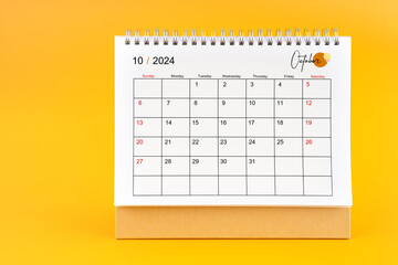 October 2024, Monthly desk calendar for 2024 year on yellow background.