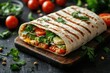 © Lubos Chlubny - Grilled tortilla wrap with avocado, tomatoes, red onion, cilantro and pine nuts, lying on wooden cutting board