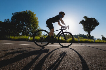 Wall Mural - Woman cycling on summer park trail