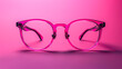 © Alina Tymofieieva - Close-up of a dark eyeglass frame on a bright pink background. Copy space. Design concept.