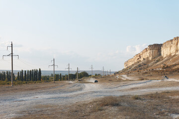 Wall Mural - scenic country road with blue skies and rolling hills in the background