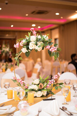 Wall Mural - Amazing Floral decoration on table in a ballroom background