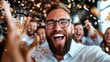© Pinklife - A joyous man in glasses celebrating with friends, surrounded by confetti and holding a drink, capturing the essence of happiness and festive moments at a lively party.