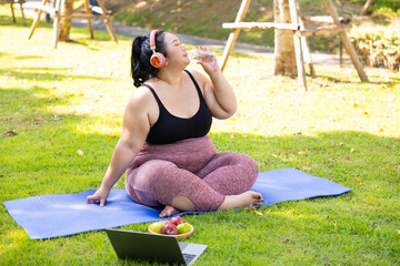 Drinking water. beautiful young chubby overweight woman in sportswear doing exercise outdoors at park. fitness sport club, body and health care