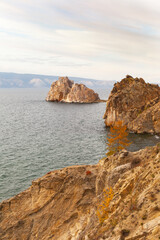 Wall Mural - Baikal Lake on October. View of rocky coast of Olkhon Island in Khuzhir village. Famous Shamanka Rock - natural landmark of lake. Scenic autumn landscape on sunset. Natural background