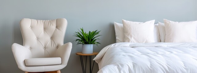 Wall Mural -  A bed with a white comforter, a chair in white next to it, holding a potted plant