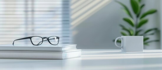 white desk with glasses and books on it, blurred background of an office room with light colors