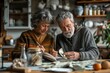 © cochisevisuals - Senior couple planning their finances while sitting at the kitchen table.